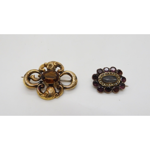 500 - A collection of mourning jewellery, a garnet and pearl yellow metal brooch with a hair panel, approx... 