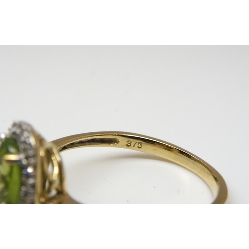 510 - A 9ct gold peridot and diamond cluster ring set with estimated approx 0.10cts of brilliant cut diamo... 