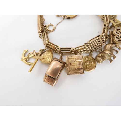 586 - An extensive 9ct gold tapered bar bracelet with heart shaped clasp, hung with, thirteen 9ct and yell... 