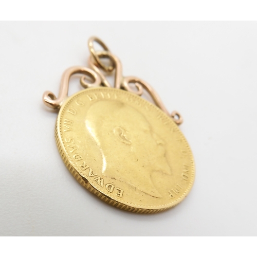 586A - A 1910 gold full sovereign with soldered on yellow metal mount, weight 8.9gms