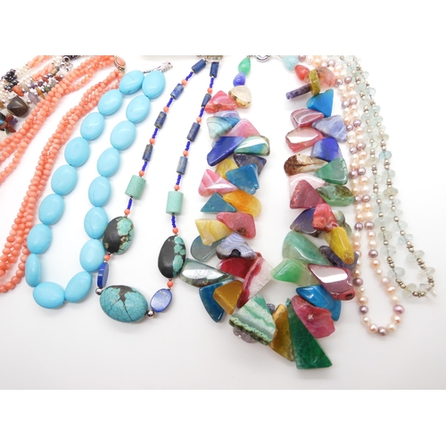 592 - A collection of gem stone necklaces, to include a multi colour agate statement necklace, coral beads... 