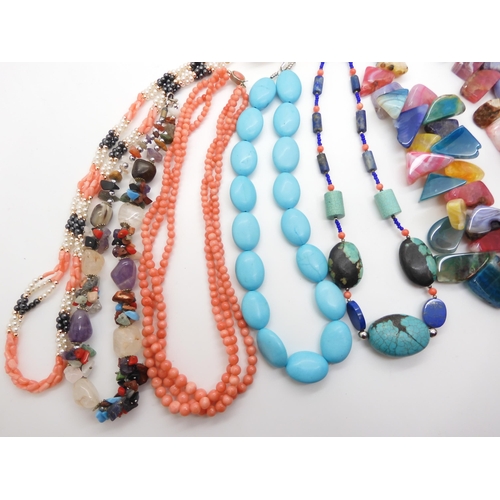 592 - A collection of gem stone necklaces, to include a multi colour agate statement necklace, coral beads... 