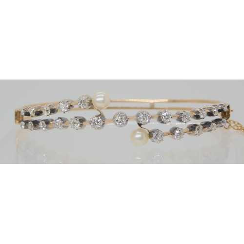 2721 - A VINTAGE DIAMOND AND PEARL BANGLEset with 1.40cts of old cut diamonds, largest diamond approx 0.12c... 