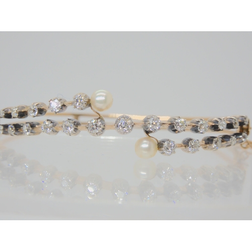 2721 - A VINTAGE DIAMOND AND PEARL BANGLEset with 1.40cts of old cut diamonds, largest diamond approx 0.12c... 