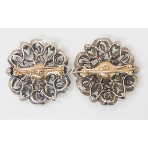 2729 - A PAIR OF EMERALD AND DIAMOND BROOCHESthe gems set into white metal mounts with yellow metal pins an... 