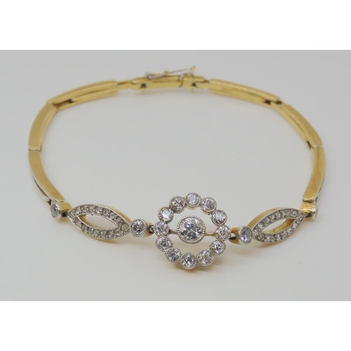 2730 - A VINTAGE DIAMOND BRACELETthe sprung links are stamped 18ct and are white metal topped, set with est... 