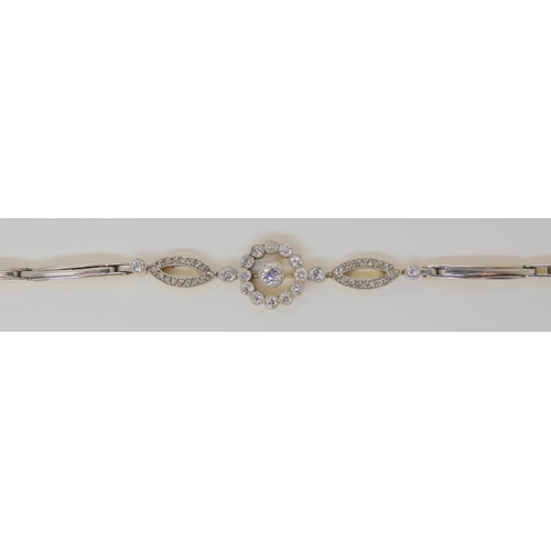 2730 - A VINTAGE DIAMOND BRACELETthe sprung links are stamped 18ct and are white metal topped, set with est... 