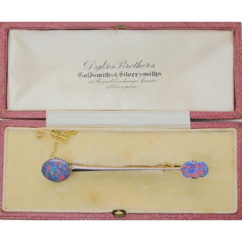 2737 - AN OPAL BAR BROOCHthe yellow and white metal bar brooch, is set with two lively opal doublets. Brooc... 