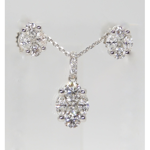 2745 - A DIAMOND PENDANT AND EARRING SETAn 18ct white gold diamond set pendant set with brilliant cuts, mar... 