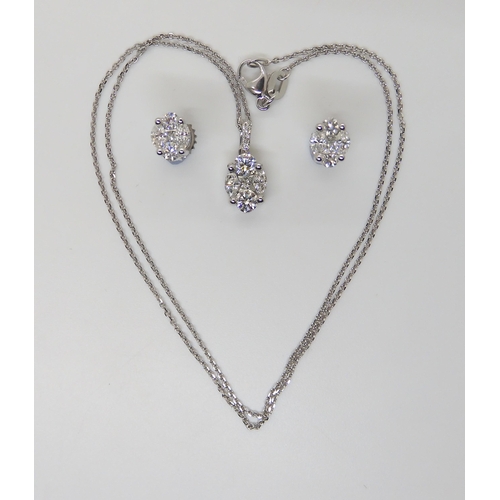 2745 - A DIAMOND PENDANT AND EARRING SETAn 18ct white gold diamond set pendant set with brilliant cuts, mar... 