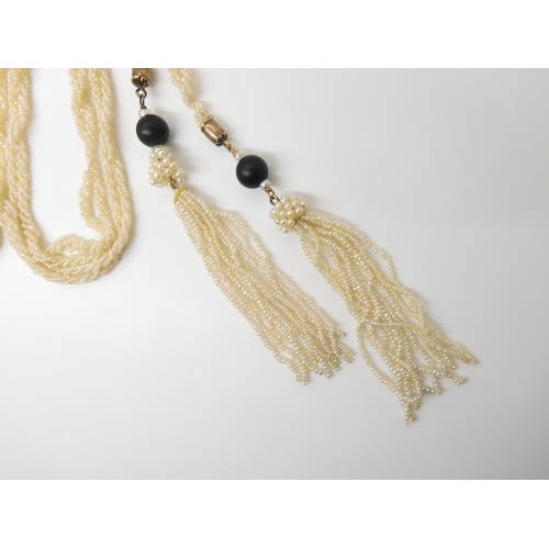 2747 - A SEED PEARL LARIAT NECKLACEwith tasselled ends with a black glass bead finial, length 144cm, weight... 