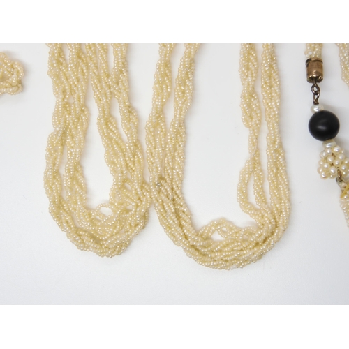 2747 - A SEED PEARL LARIAT NECKLACEwith tasselled ends with a black glass bead finial, length 144cm, weight... 