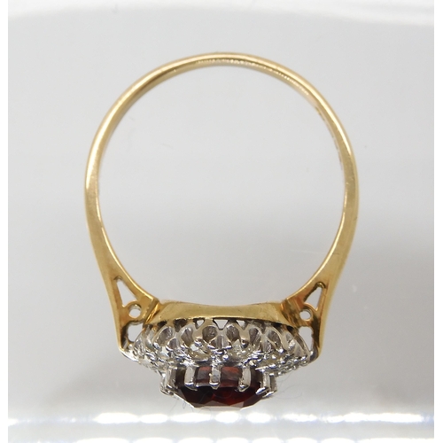 2749 - A GARNET AND DIAMOND CLUSTER RINGmounted throughout in 18ct gold, the garnet is approx 7mm, and set ... 
