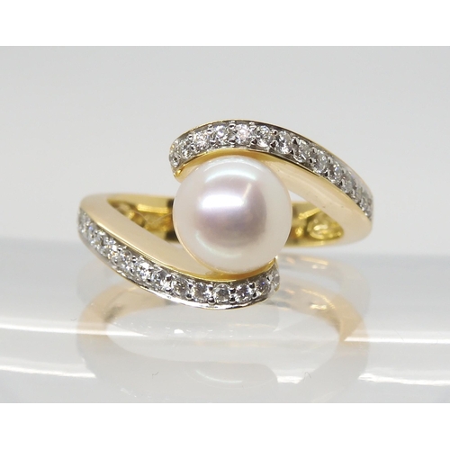 2756 - A DIAMOND AND PEARL RINGmounted in 18ct yellow gold the 7.6mm pearl is flanked with two rows of bril... 