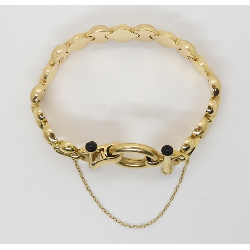 2758 - AN 18CT GOLD BRACELETWith fancy shiny and textured links with onyx terminals to the clasp. Length ap... 