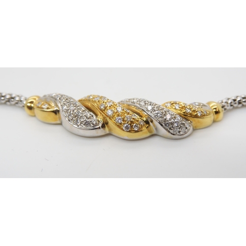 2760 - AN 18CT GOLD DIAMOND NECKLETset throughout in yellow and white gold, with pave set diamonds to the t... 