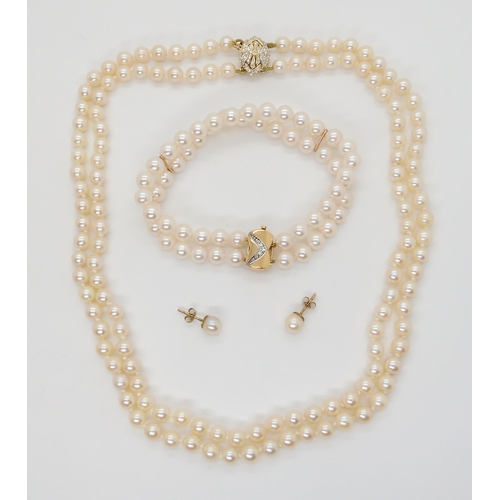 2762 - PEARLS WITH A FANCY DIAMOND CLASPThe double string of pearls are uniform in size, approx 5.6mm, the ... 