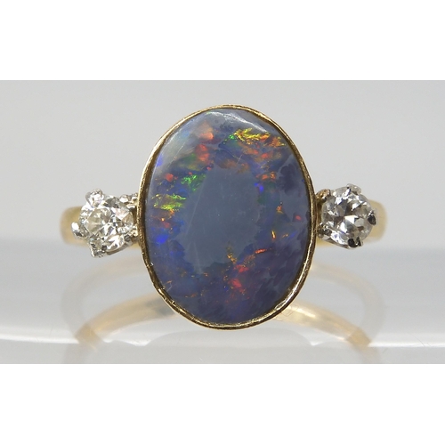 2769 - A BLACK OPAL & DIAMOND RINGset with an estimated approx 12.5mm x 10mm x 3.1mm, black opal, flank... 