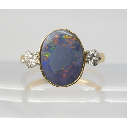 2769 - A BLACK OPAL & DIAMOND RINGset with an estimated approx 12.5mm x 10mm x 3.1mm, black opal, flank... 