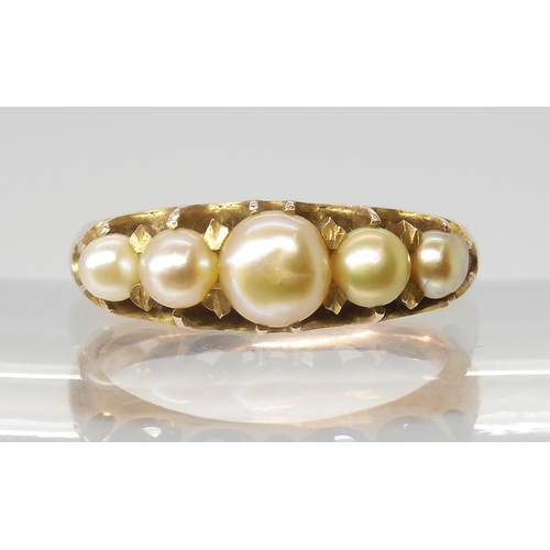 2772 - A VINTAGE PEARL RINGset with five freeform cream pearls with good lustre, in a yellow metal traditio... 