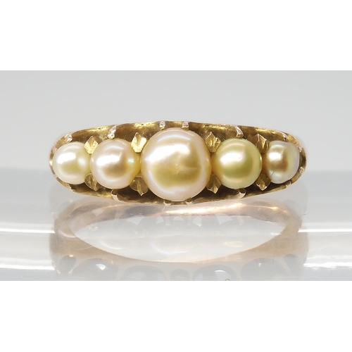 2772 - A VINTAGE PEARL RINGset with five freeform cream pearls with good lustre, in a yellow metal traditio... 