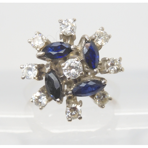 2774 - A RETRO SAPPHIRE & DIAMOND CLUSTER RINGset throughout in white metal, the four blue marquis cut ... 
