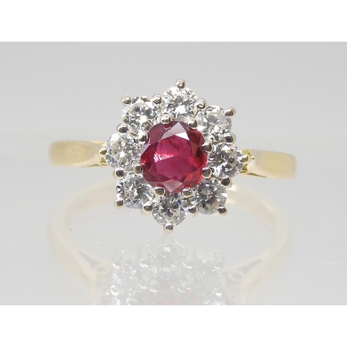 2786 - A RUBY & DIAMOND FLOWER RINGmounted throughout in 18ct yellow gold, set with estimated approx 0.... 
