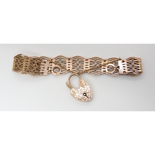 2797 - A 9CT GATE BRACELETwith an engraved heart shaped clasp, and decorative patterned links, length 18cm,... 