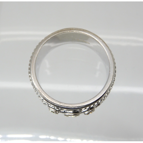 2801 - A 9CT WHITE GOLD DIAMOND RINGthe wide band ring is set with three diamonds, with an approximate diam... 