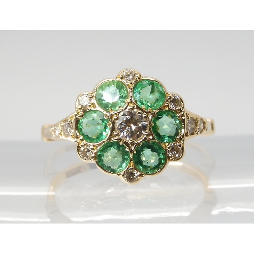 2806 - AN EMERALD & DIAMOND FLOWER RINGset throughout in 15ct gold, finger size N, weight 2.4gms... 