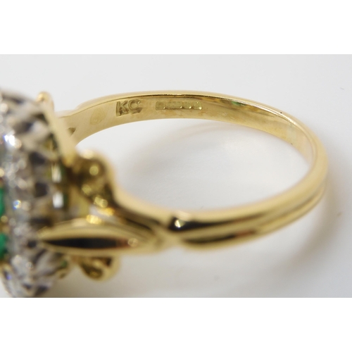 2813 - AN EMERALD & DIAMOND CLUSTER RINGset throughout in 18ct yellow and white gold, with fleur de lys... 