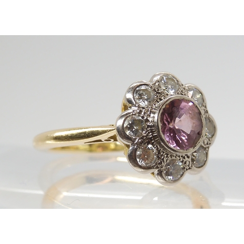 2816 - A PINK SAPPHIRE & DIAMOND FLOWER CLUSTERset throughout in bright yellow and white metal, the cen... 