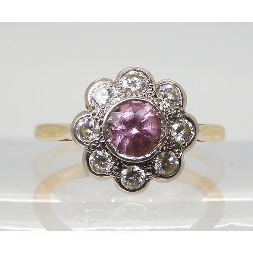 2816 - A PINK SAPPHIRE & DIAMOND FLOWER CLUSTERset throughout in bright yellow and white metal, the cen... 