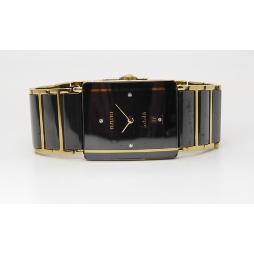 2893 - A RADO JUBILEwith black diamond set oblong dial with date aperture and gold coloured hands, with a g... 