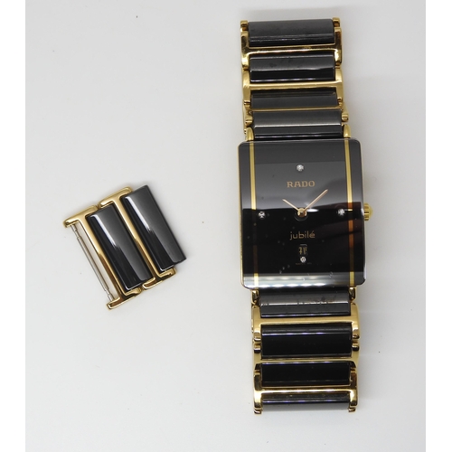 2893 - A RADO JUBILEwith black diamond set oblong dial with date aperture and gold coloured hands, with a g... 