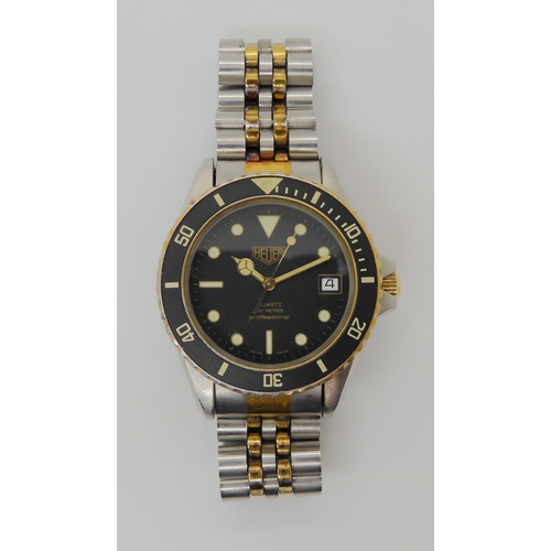 2908 - A VINTAGE HEUER WRISTWATCHcirca 1983, steel and gold plate diver's watch.  The watch has a black dia... 
