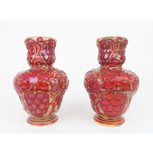 2174 - A PAIR OF LATE 19TH CENTURY CRAVEN DUNNILL JACKFIELD POTTERY VASESwith red lustre glaze over relief ... 