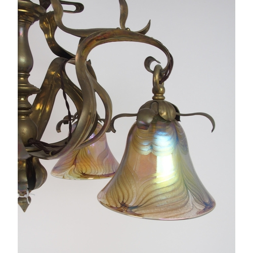 2204 - A BRASS ARTS AND CRAFTS HANGING LIGHTwith later iridescent glass shades, 56.6cm x 59cm high, 104 cm ... 