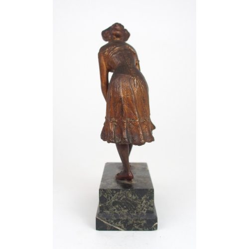 2209 - IN THE STYLE OF FRANZ BERGMANA cold painted bronze figure of a woman in petticoats, tying her stocki... 
