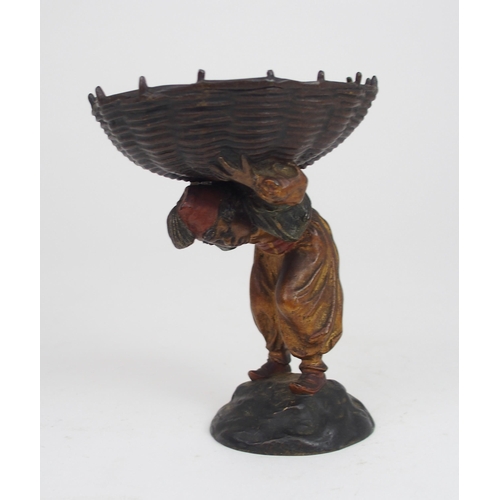 2210 - AN EARLY 20TH CENTURY COLD PAINTED BRONZE OF A BOY wearing a fez, and carrying a large basket on his... 