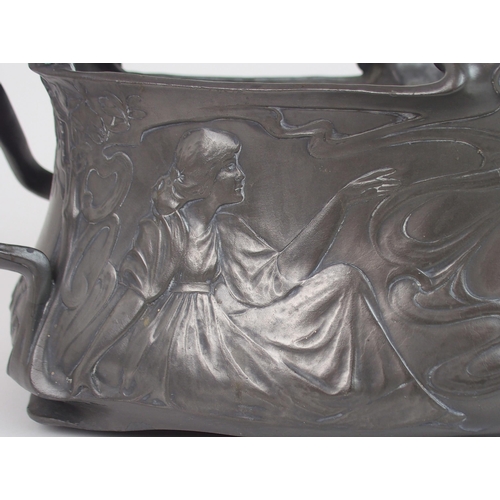 2227 - A PROBABLY GERMAN TWO HANDLED PEWTER JUGENDSTIL JARDINIEREdecorated with maidens sitting around a fi... 