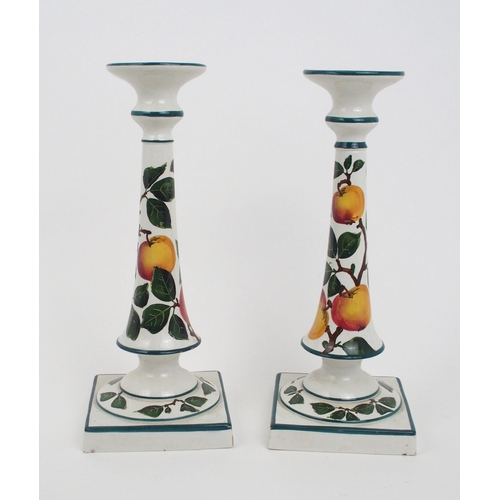 2242 - A PAIR OF ROBERT HERON AND SONS WEMYSS CANDLESTICKSpainted with apples, 30c high, a similarly painte... 