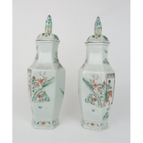 2359 - A PAIR OF CANTON HEXAGONAL VASES AND COVERS painted with horse riders before dignitaries on balconie... 