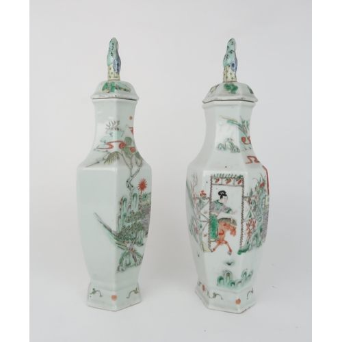 2359 - A PAIR OF CANTON HEXAGONAL VASES AND COVERS painted with horse riders before dignitaries on balconie... 