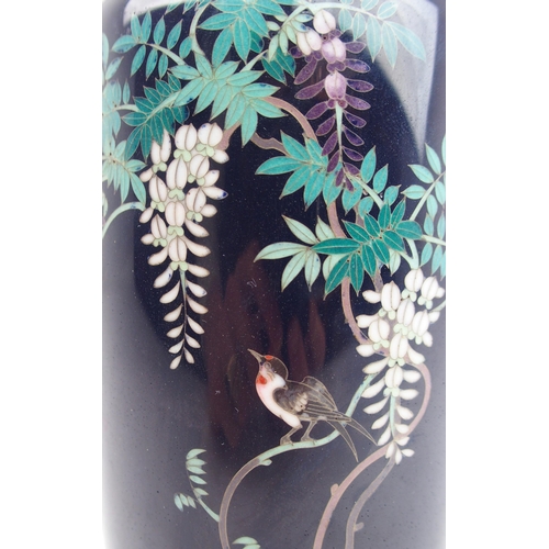 2362 - A JAPANESE CLOISONNE BALUSTER VASE decorated with a bird amongst wisteria branches and above flowers... 