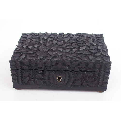 2396 - AN ANGLO-INDIAN EBONY HINGED BOX carved all over with foliage, 6cm high,15.5cm wide and 10cm deep, a... 