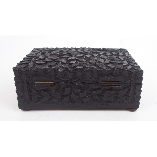 2396 - AN ANGLO-INDIAN EBONY HINGED BOX carved all over with foliage, 6cm high,15.5cm wide and 10cm deep, a... 