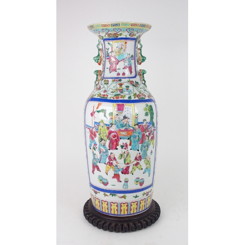 2398 - A CANTONESE BALUSTER VASE painted with court figures surrounded by precious objects and foliage, 20t... 