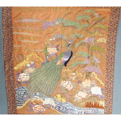 2407 -  A CHINESE SILK PANELwoven with a peacock in a garden and beneath pine, within a machine woven borde... 