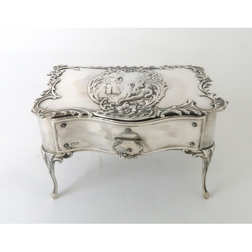 2452 - AN EDWARDIAN SILVER JEWELLERY BOXby William Comyns, Birmingham 1902, in the form of a rococo table, ... 